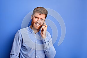 Excited caucasian male talk on phone with someone