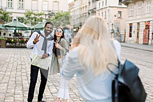 Excited cheerful mix raced couple, African man and Caucasian girl, enjoying walking outdoors, in the center of ancient