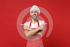 Excited chef cook baker man in striped apron white t-shirt toque chefs hat posing isolated on red background. Cooking