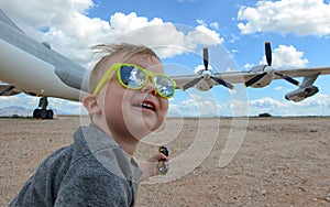 Excited child and airplane at airport