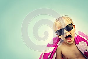 Excited Child in Beach Towel on Summer Day
