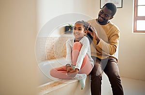 Excited child, father and brushing hair in family home bathroom with love and support. Black man teaching kid self care