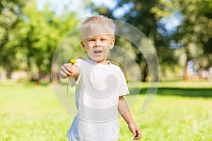 Excited child holding a beautiful flower n the hand