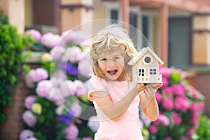 Excited child making a new dream home. Housing a young family. Amazed boy dream new home.