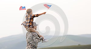 Excited child sitting with american flag on shoulders of father reunited with family