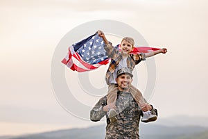 Excited child sitting with american flag on shoulders of father reunited with family