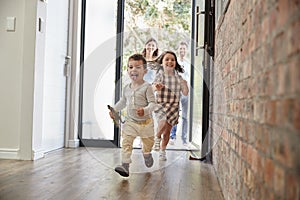 Excited Children Arriving Home With Parents