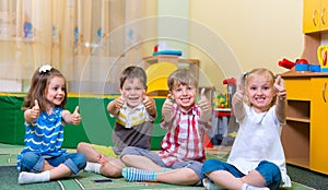 Excited children holding thumbs up
