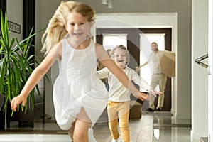 Excited children running on camera, family moving in new house