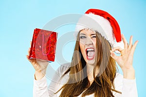 Excited christmas woman holds gift bag