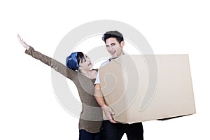 Excited couple bring box - isolated