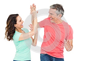 Excited couple giving a high-five photo