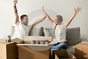 Excited couple glad to move into new home celebrating together photo