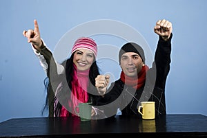 Excited couple at table in winter season