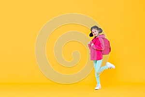 Excited cute girl with pigtail hair going to school