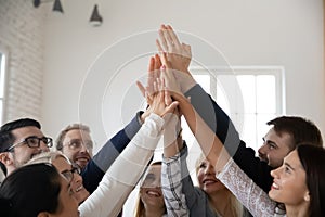 Excited diverse businesspeople give high five participate in teambuilding