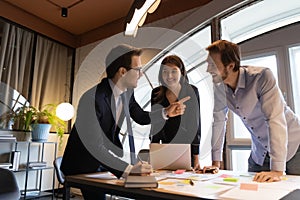 Excited diverse colleagues have fun brainstorming at meeting