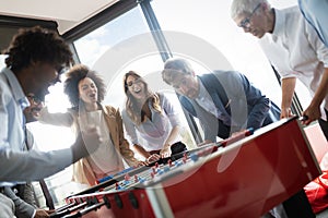 Excited diverse employees enjoying funny activity at work break, creative friendly workers play game