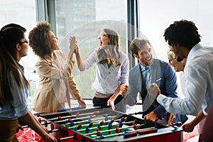 Excited diverse employees enjoying funny activity at work break, creative friendly workers play game