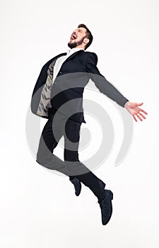 Excited elated happy young business man jumping and shouting