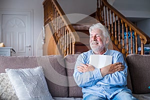 Excited elderly man celebrate health insurance deal closing looking and reading the medical results. Happy mature senior feel