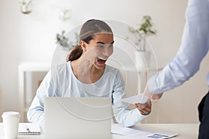 Excited employee receiving from boss envelope with money