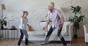 Excited energetic rocker grandpa and grandkid dancing to rock music