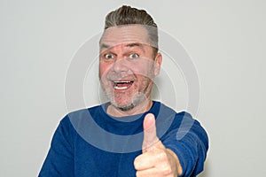 Excited enthusiastic man giving a thumbs up