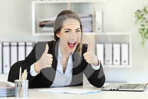 Excited executive looking at camera with thumbs up