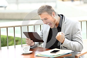 Excited executive receiving good news on line