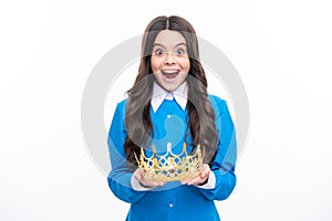 Excited face. Little queen wearing golden crown. Teenage girl princess holding crown tiara. Prom party, childhood