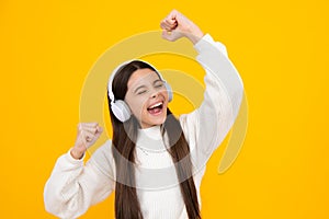 Excited face. Teen girl in headphones listen to music. Wireless headset device accessory. Child enjoys the music in
