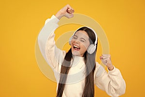 Excited face. Teen girl in headphones listen to music. Wireless headset device accessory. Child enjoys the music in