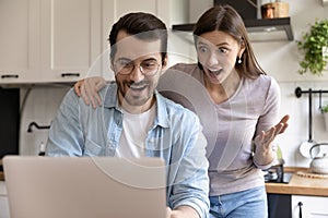 Excited family couple getting loan approval from bank by email