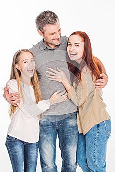 Excited family embracing together