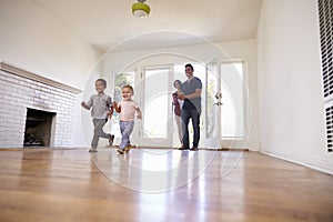 Excited Family Explore New Home On Moving Day