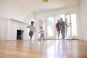 Excited Family Explore New Home On Moving Day