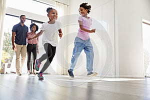 Excited Family Exploring New Home On Moving Day