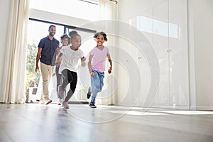 Excited Family Exploring New Home On Moving Day