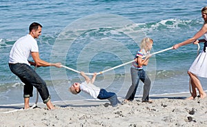 Excited family playing tug of war