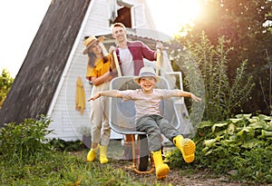 Excited family playing with wheelbarrow