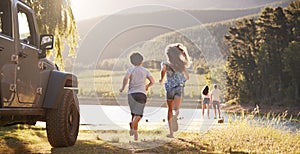 Excited Family Reaching Countryside Destination On Road Trip