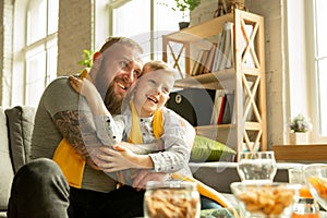 Excited family watching football, sport match at home, father and son