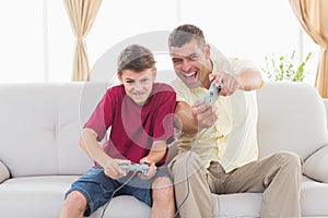 Excited father and son playing video game