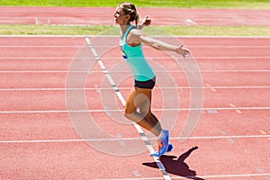 Excited female athlete posing after a victory