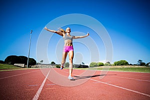 Excited female athlete posing after a victory