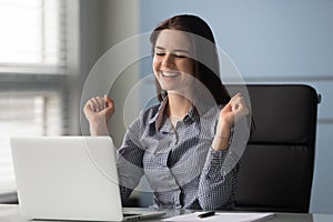 Excited female employee feel euphoric reading good news