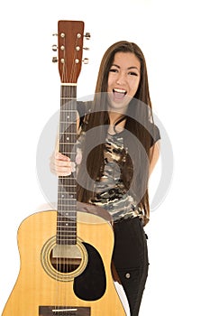 Excited female model holding out her acoustic guitar