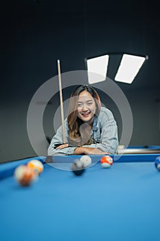 excited female pool player observing the balls