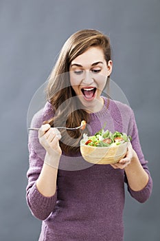 Excited fit and healthy lady ready to eat light salad